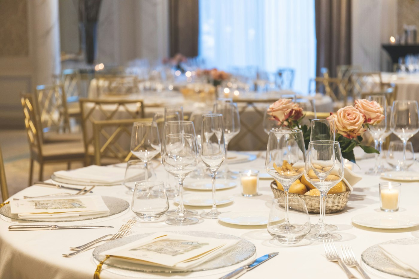 Looking across a dressed dining table inside a venue