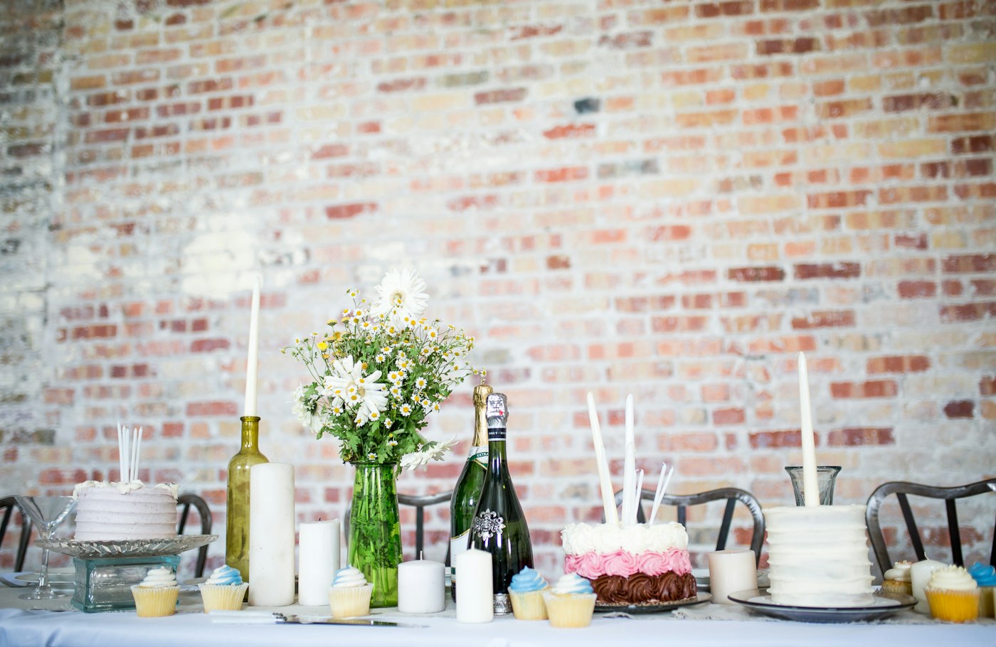 Brick-walled loft with a dessert table